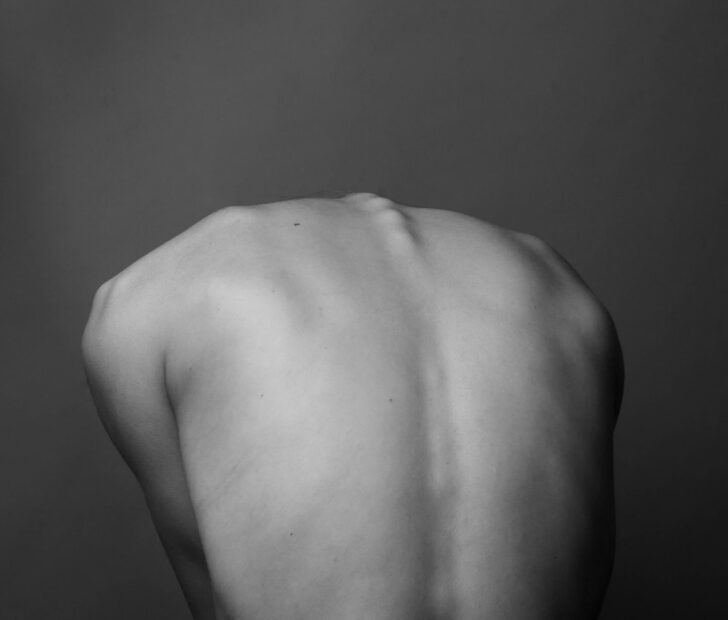 grayscale photo of persons back